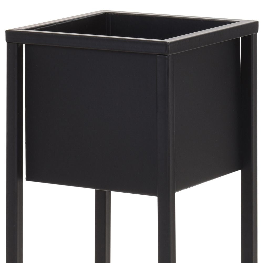 Stylish black metal flower pot on a stand
