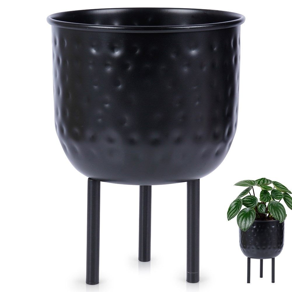 Stylish black metal pot on three legs for plants.