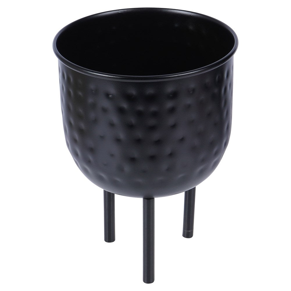 Stylish black metal pot on three legs for plants.