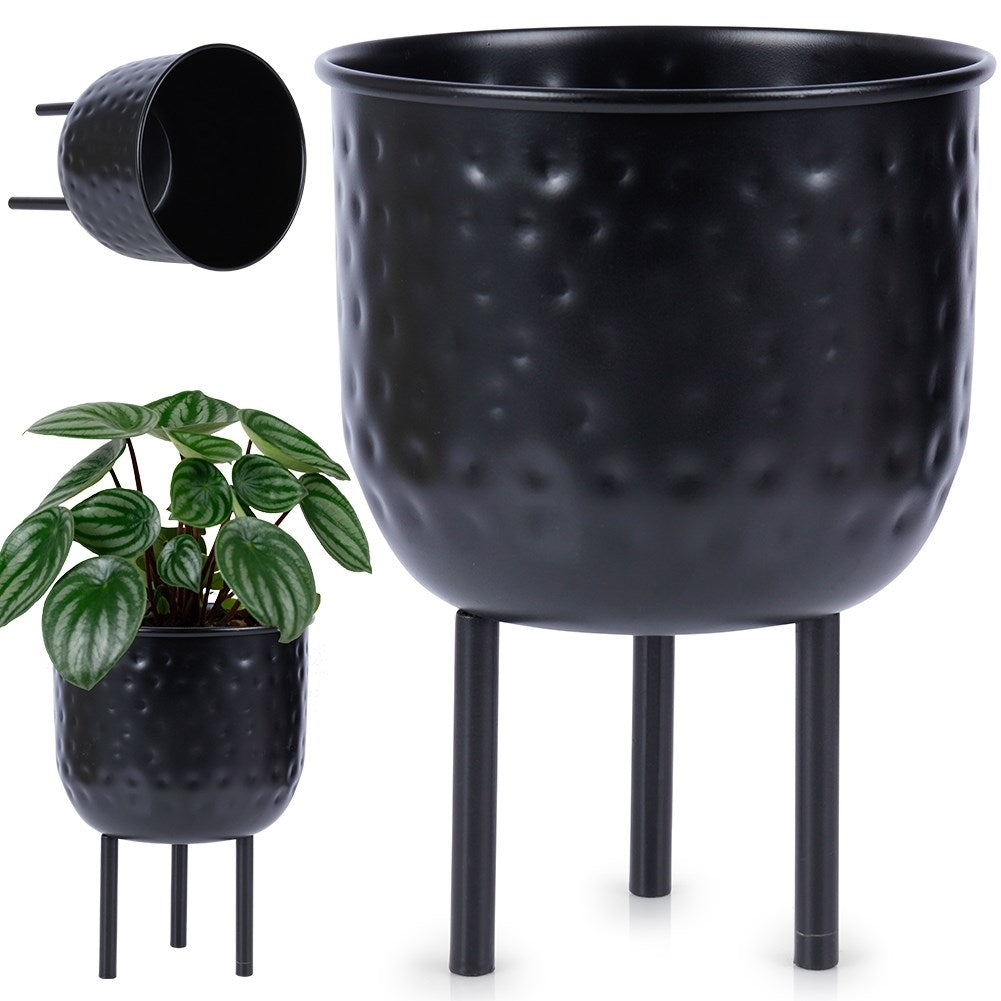Stylish black metal pot on three legs for plants.