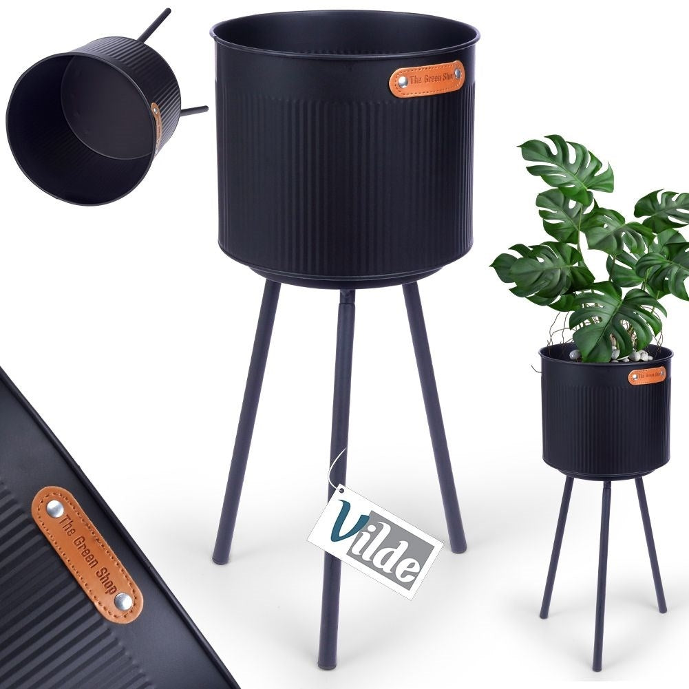 Stylish black metal pot with grooved surface and three legs