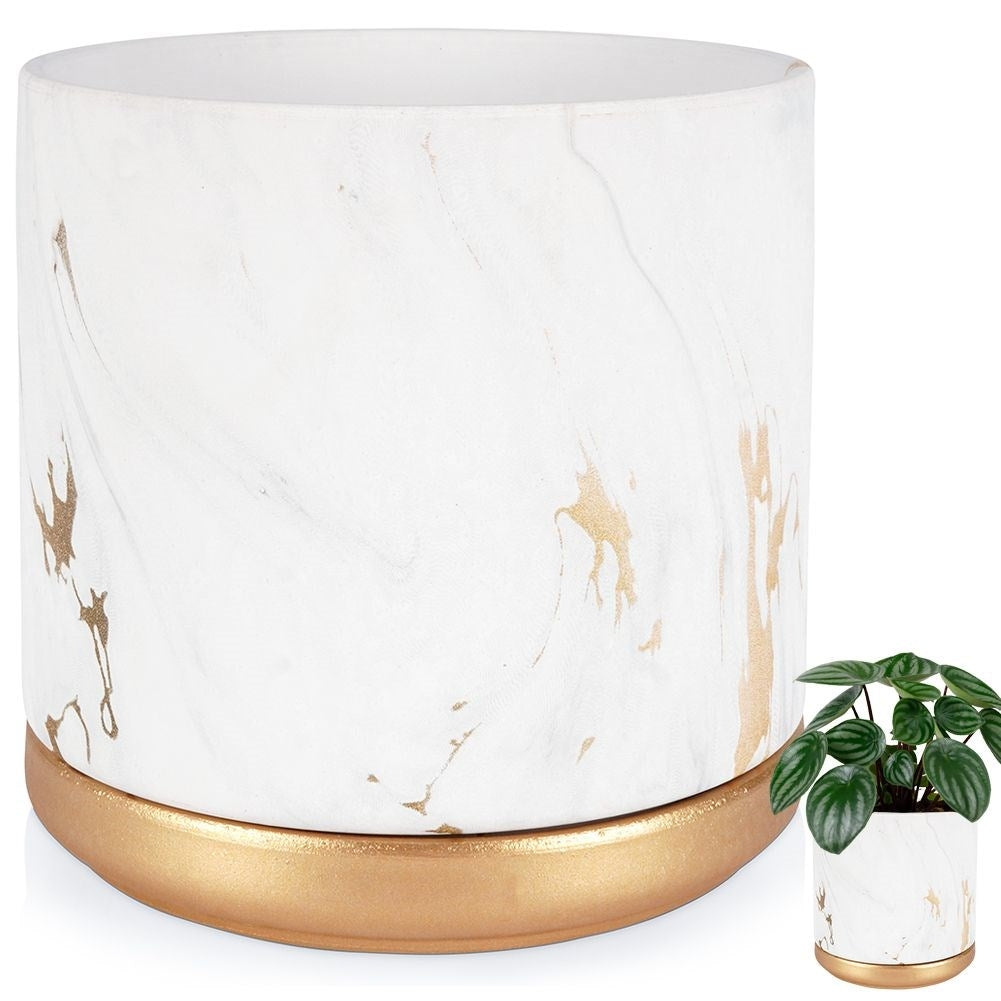 Stylish flower pot in a marble look with golden details
