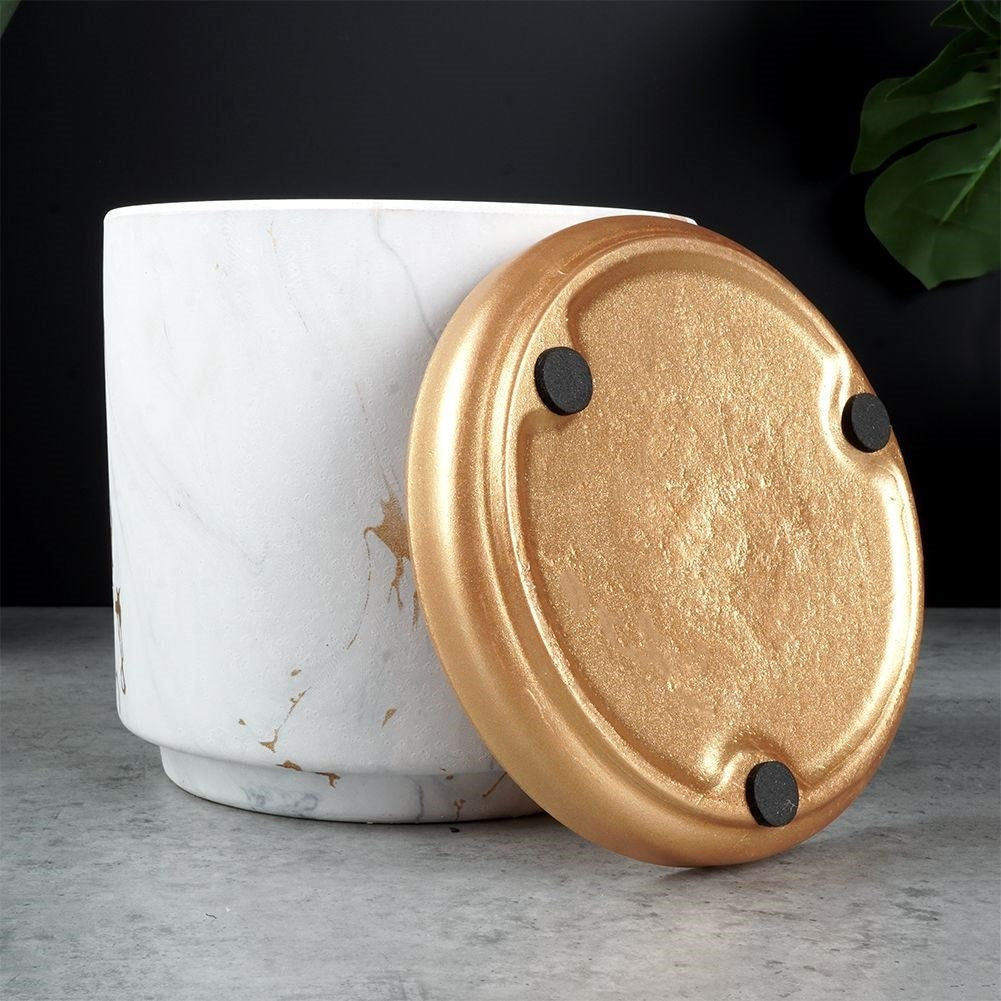 Stylish flower pot in a marble look with golden details
