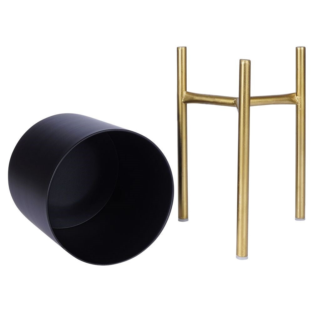 Stylish metal pot on stand in black and gold for plants