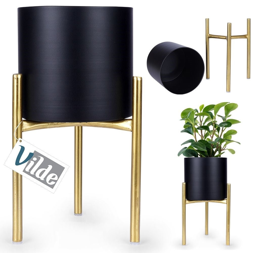 Stylish metal pot on stand in black and gold for plants