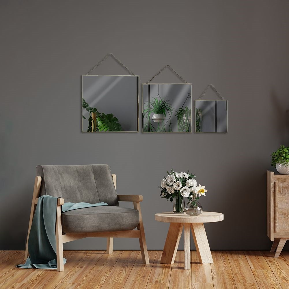 Stylish wall mirrors with golden metal frame and chain suspension