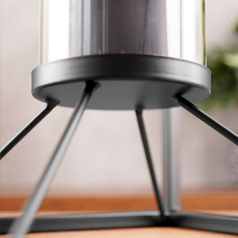 Tall candlestick in black metal with glass container