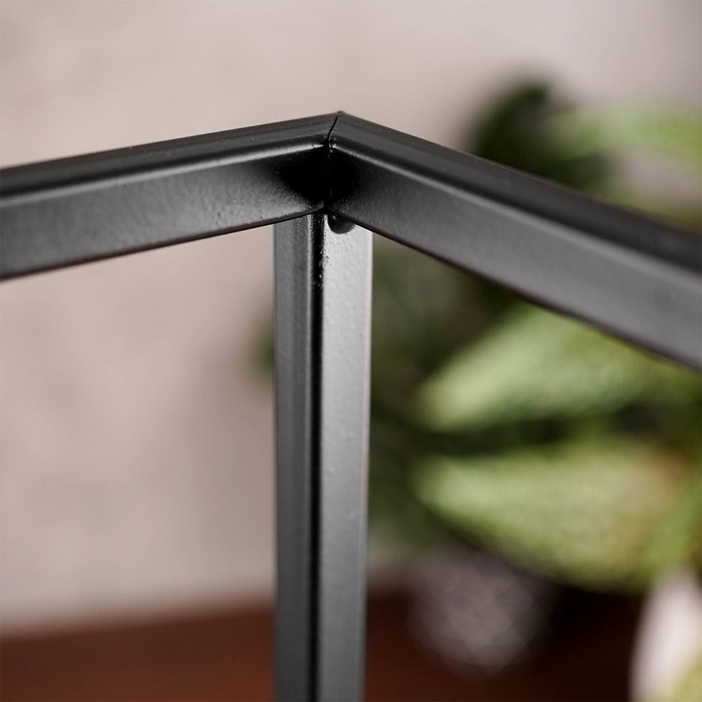 Tall candlestick in black metal with glass container