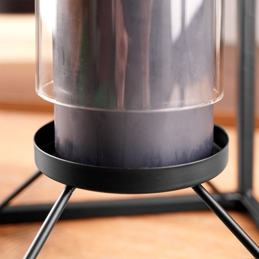 Tall candlestick in black metal with glass container