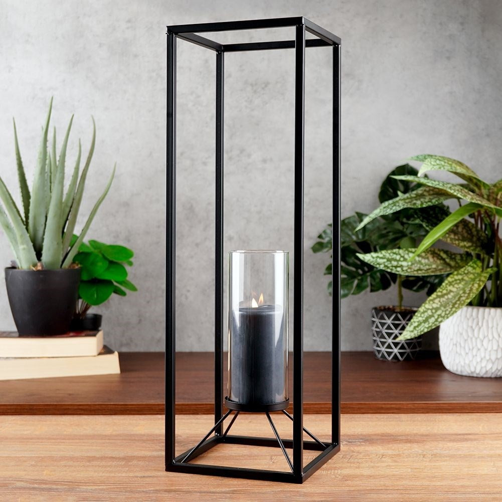 Tall candlestick in black metal with glass container