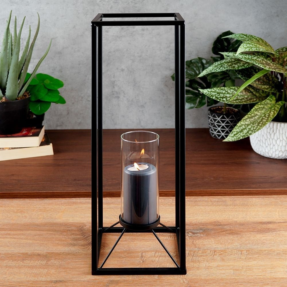 Tall candlestick in black metal with glass container