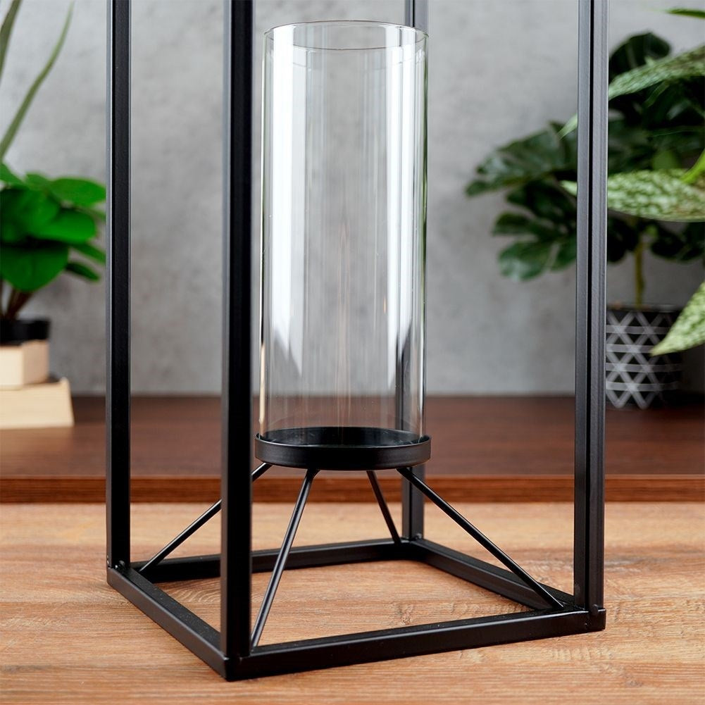Tall candlestick in black metal with glass container
