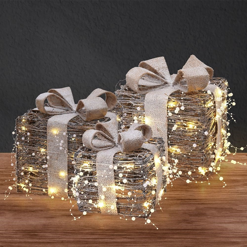 Three Christmas gifts with bright LED diodes and pearl color