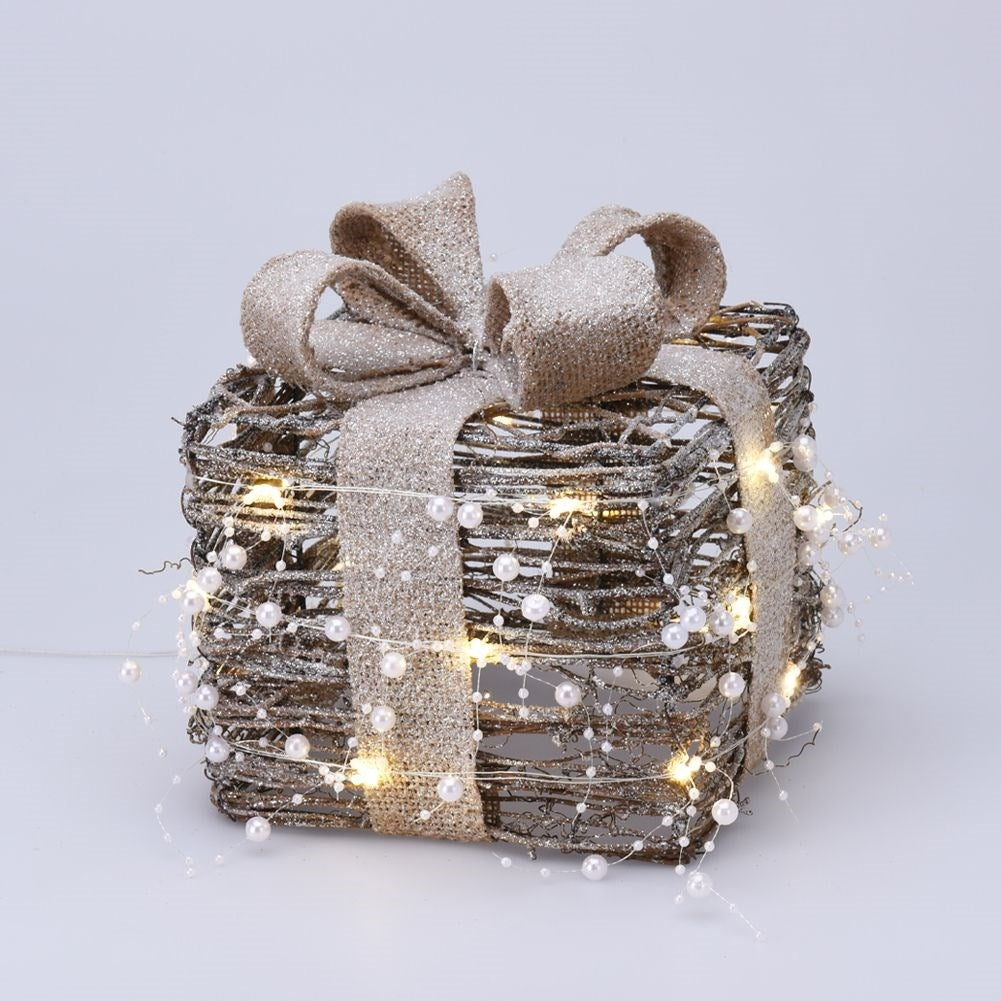 Three Christmas gifts with bright LED diodes and pearl color