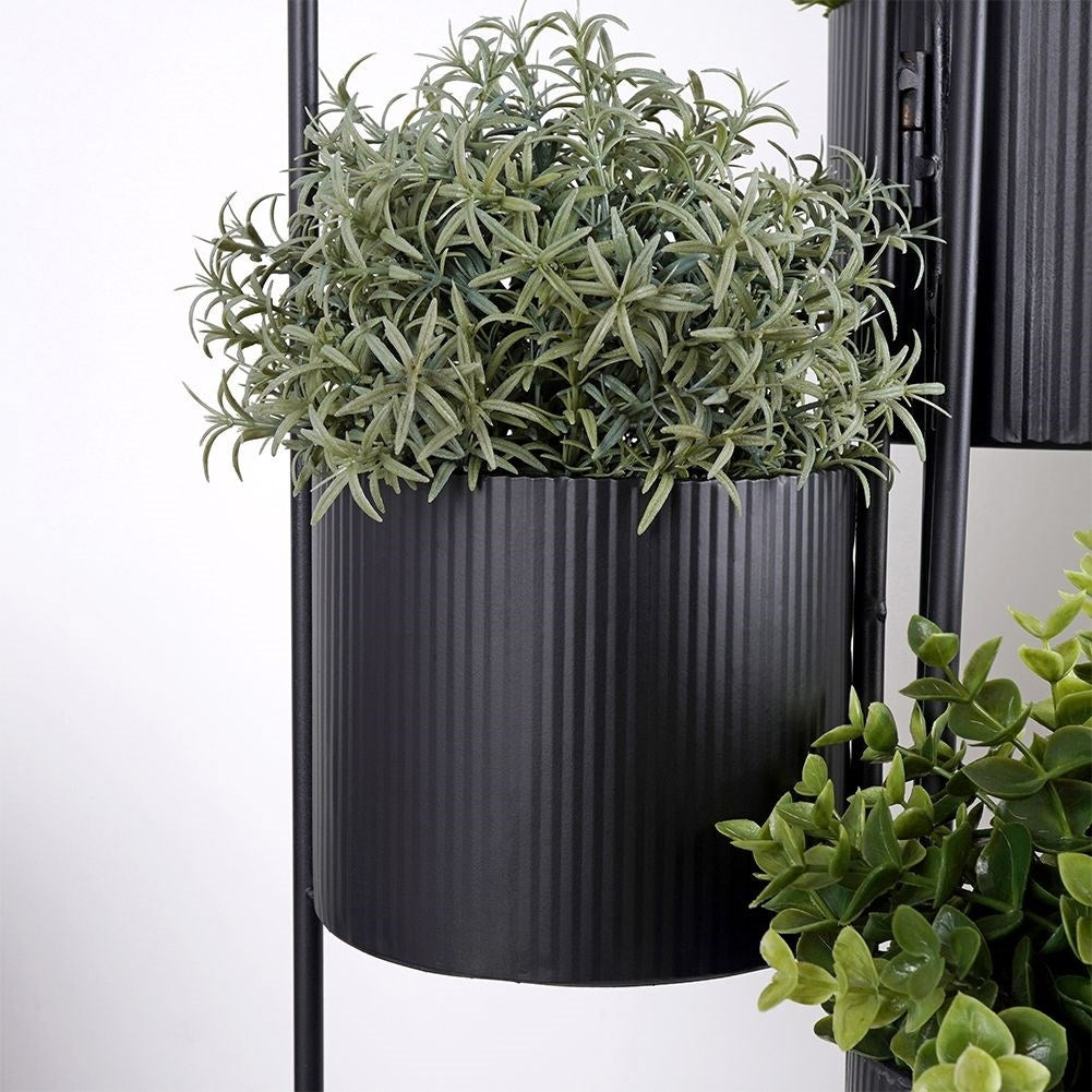 Three-legged flower stand in black metal for indoor use