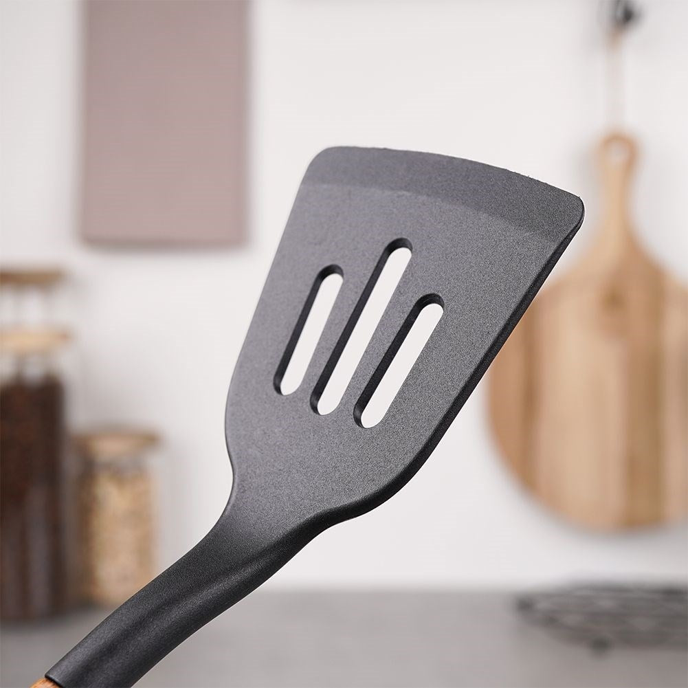 Traditional kitchen ladle in acacia wood and thermoplastic material