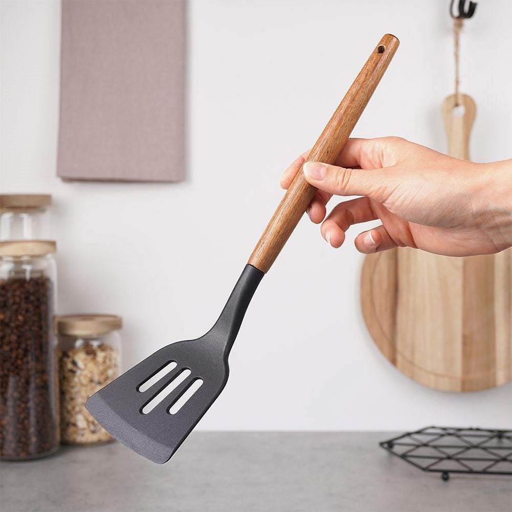 Traditional kitchen ladle in acacia wood and thermoplastic material