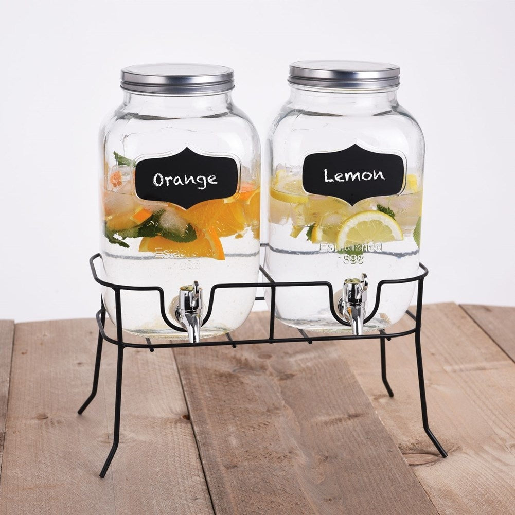 Two beverage containers with taps and metal lids on racks
