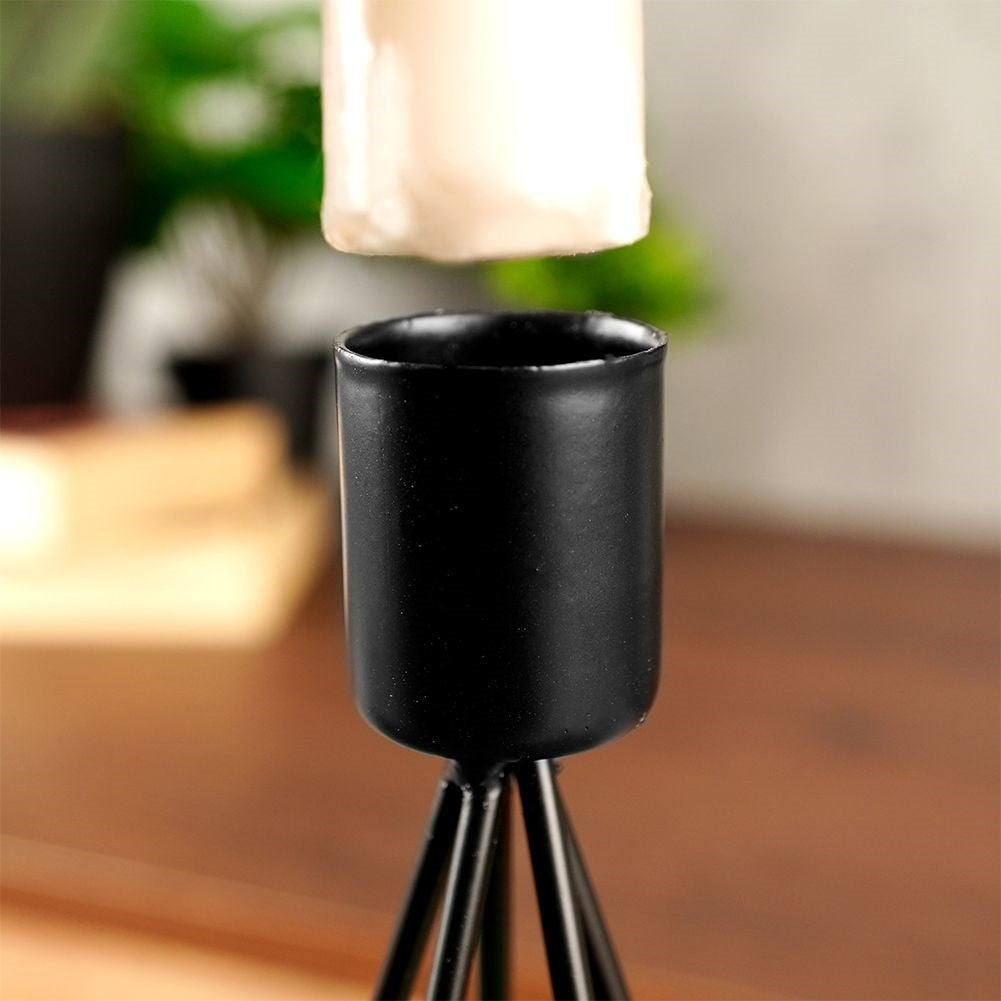Two black metal candlesticks with star base