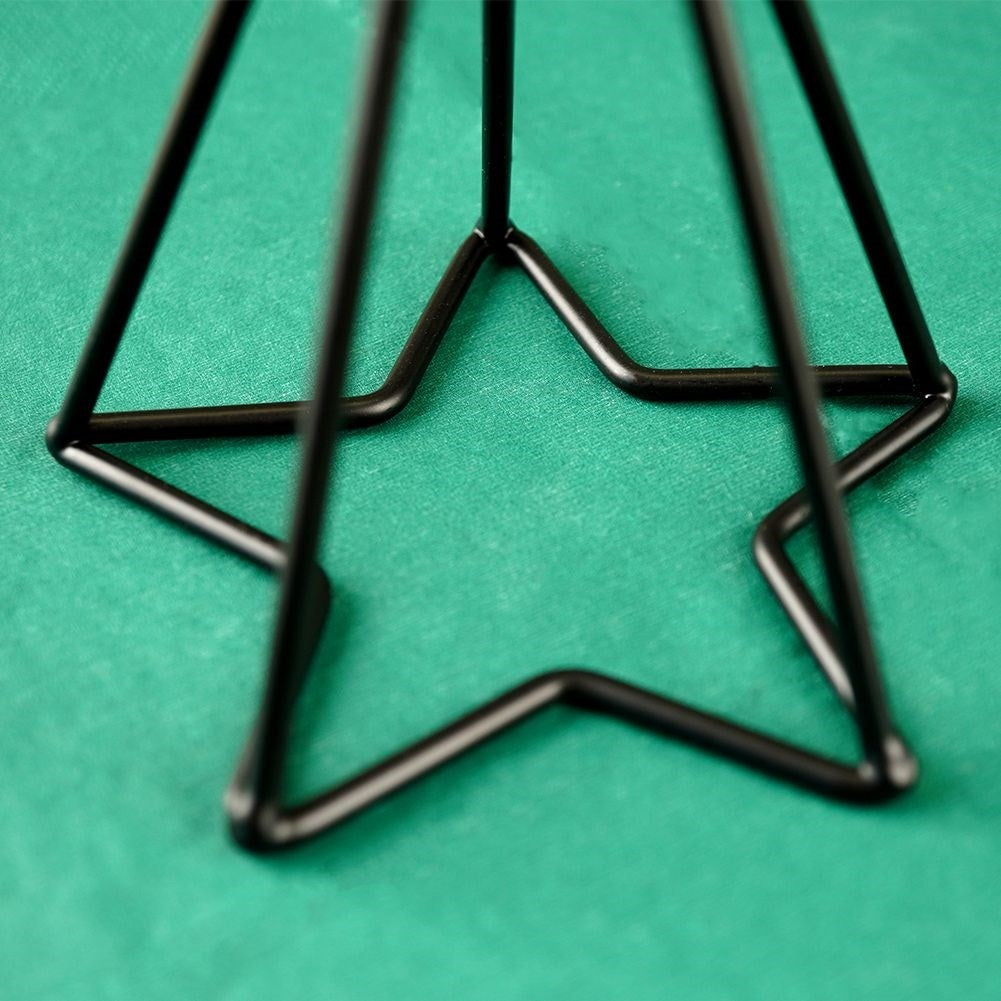 Two black metal candlesticks with star base