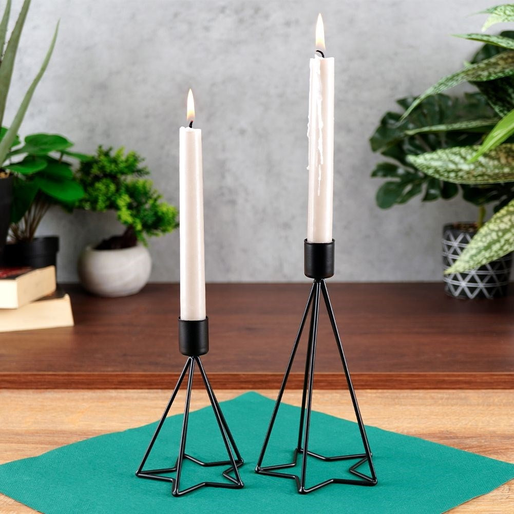 Two black metal candlesticks with star base