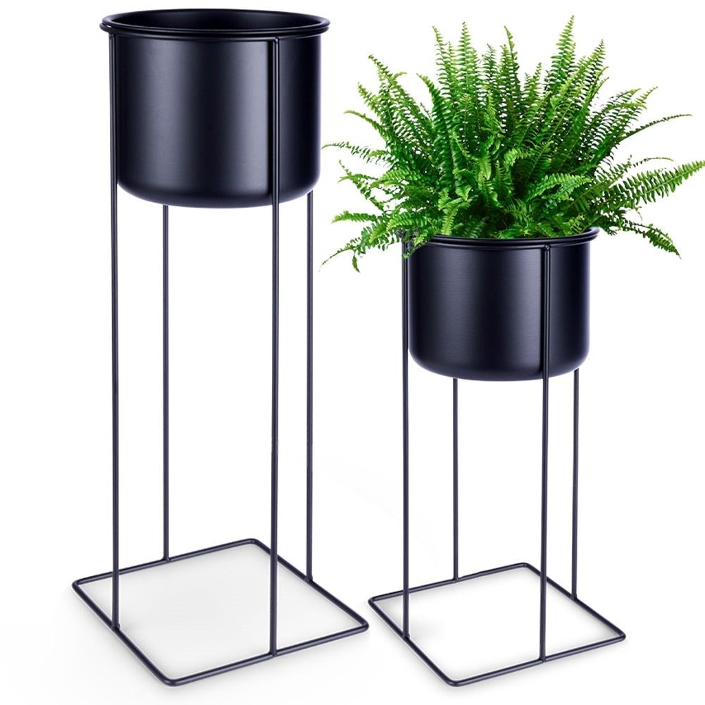 Two black metal pots with stands, different sizes
