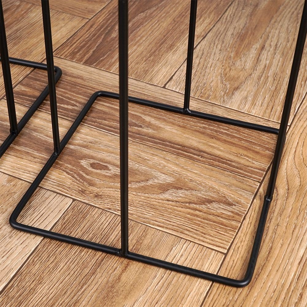 Two black metal pots with stands, different sizes