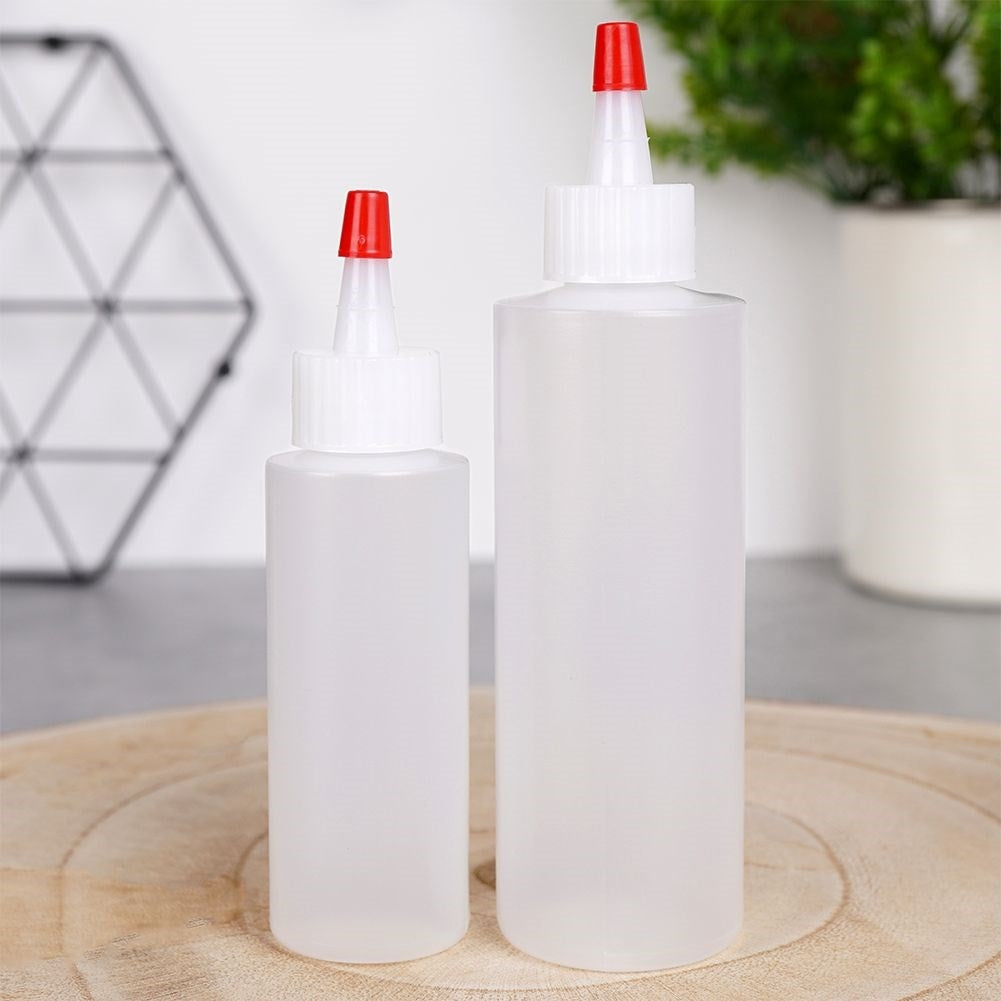 Two bottles for cake decoration, sauce dosage with lid