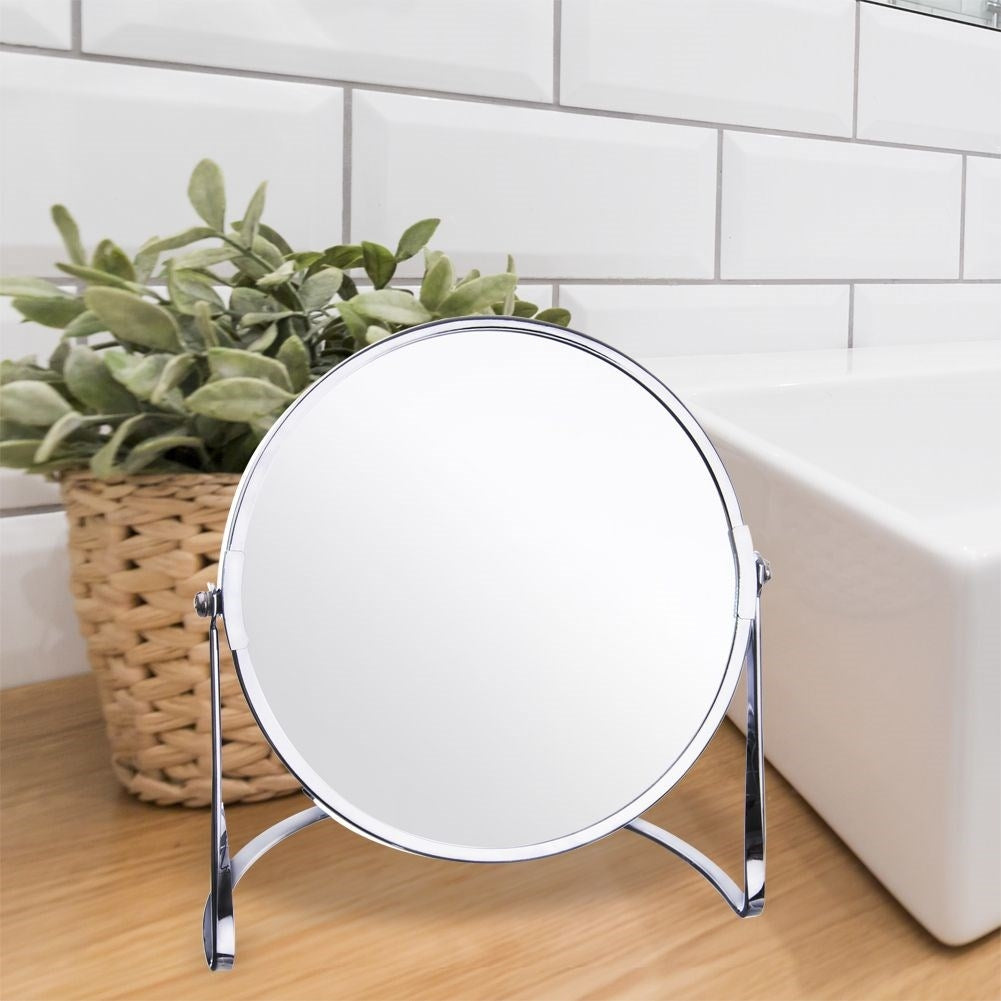 Two-sided make-up mirror with silver frame and magnifying function