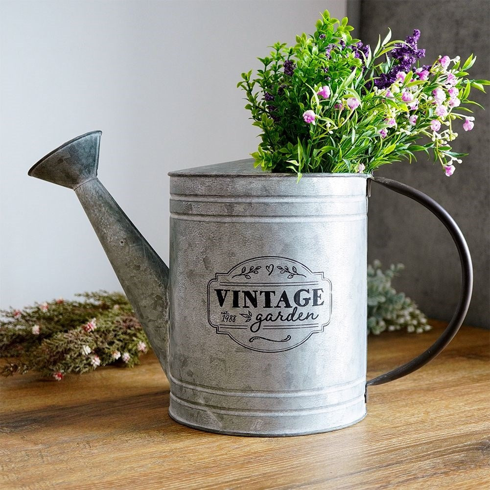 Unique metal watering can for garden decoration and flower arrangements