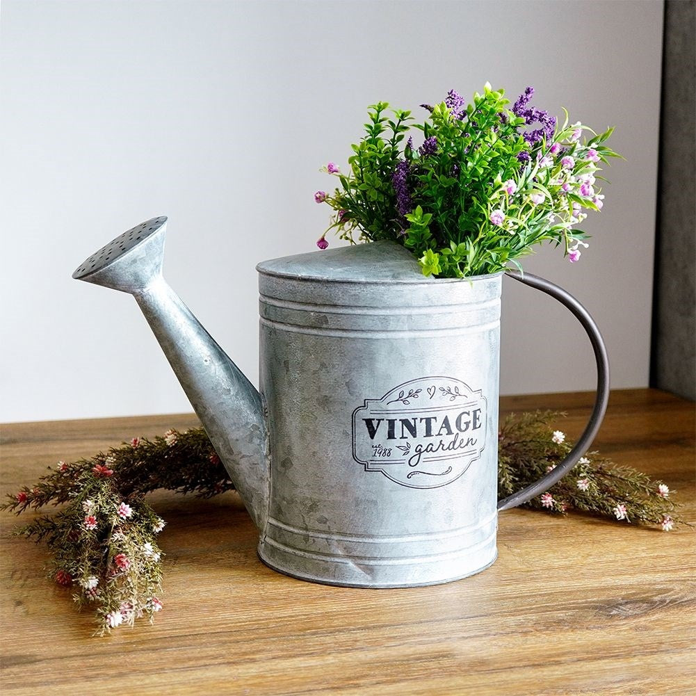 Unique metal watering can for garden decoration and flower arrangements