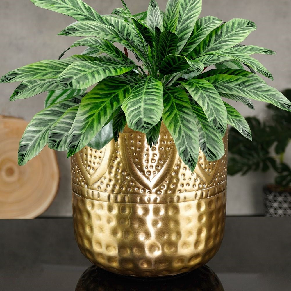 Unique plant pot in hammered brass with an eye-catching design