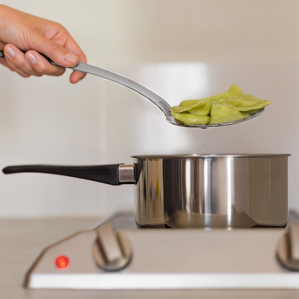 Universal kitchen spoon in stainless steel for draining food