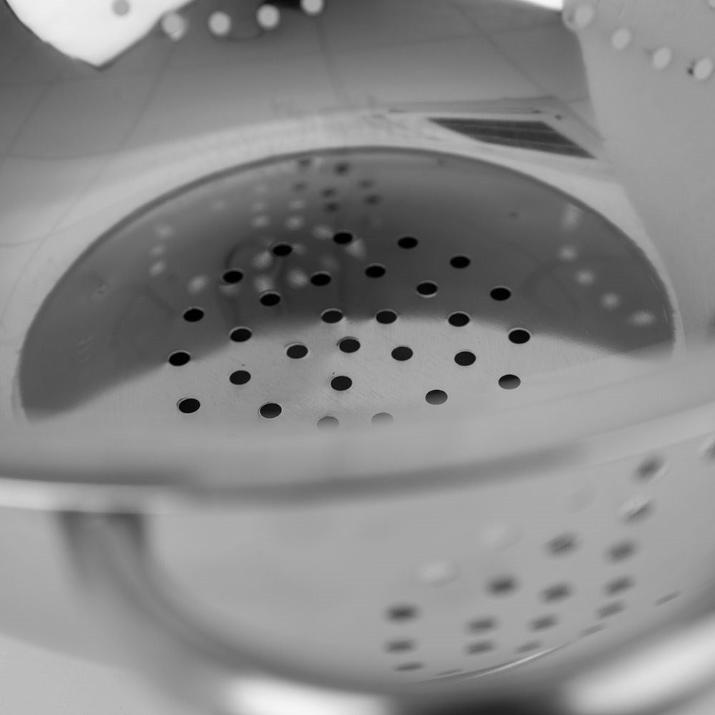 Universal kitchen strainer in bowl shape with two stainless steel handles