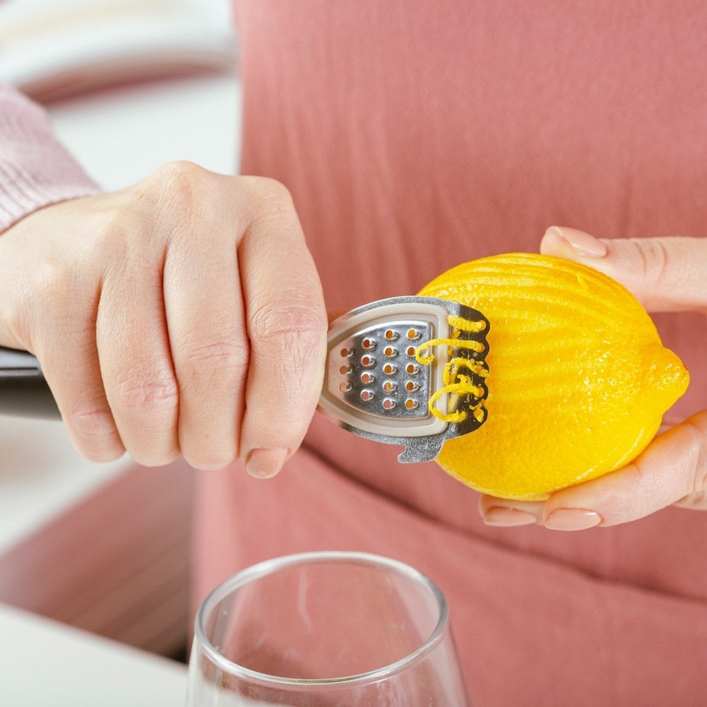 Versatile citrus press with scraper, grater and core remover