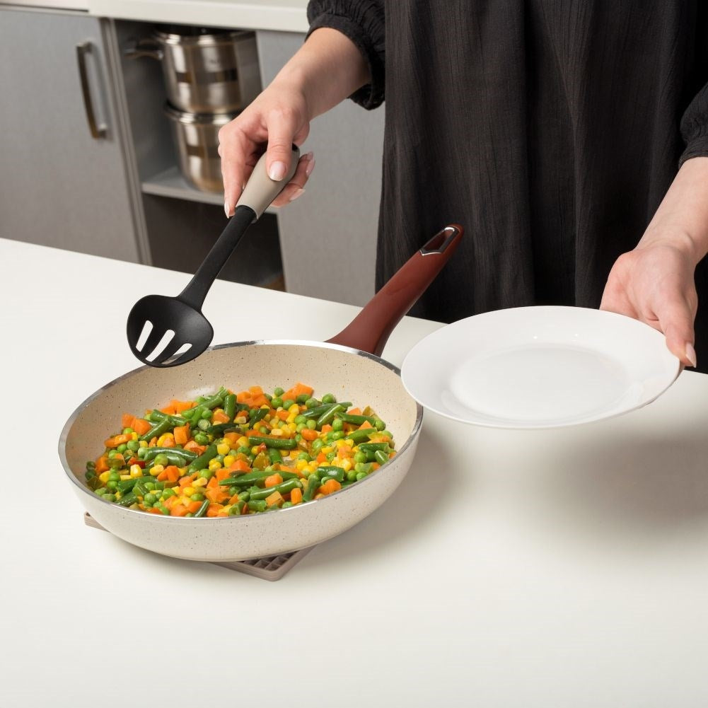 Versatile kitchen ladle in durable thermoplastic for draining