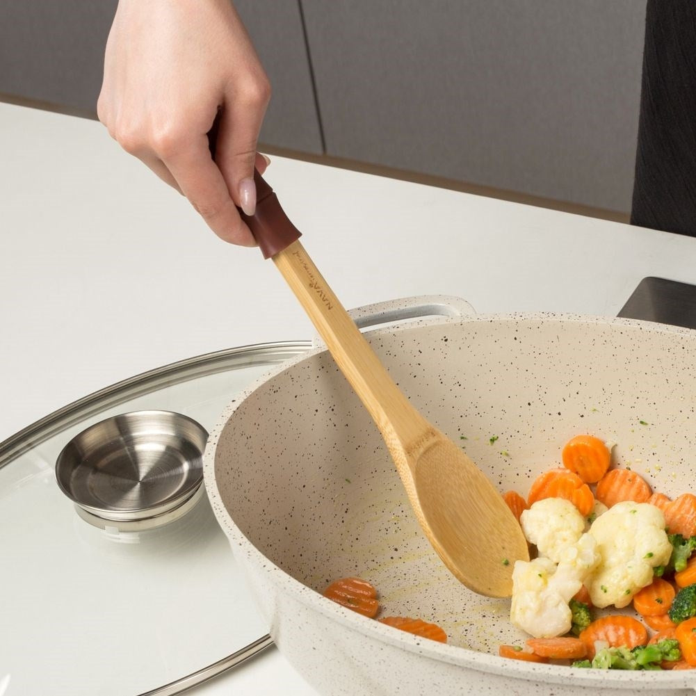 Versatile kitchen spoon in bamboo and silicone for cooking