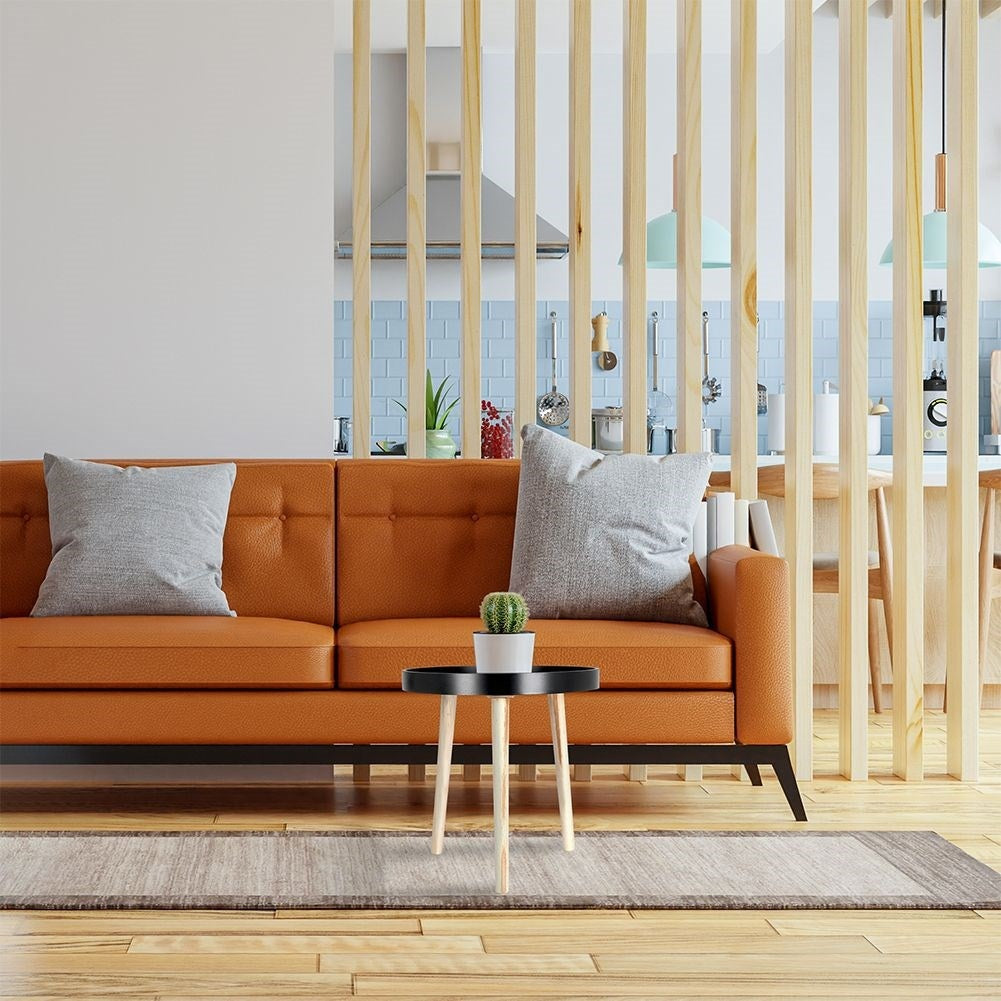 Versatile wooden coffee table with black table top and three legs
