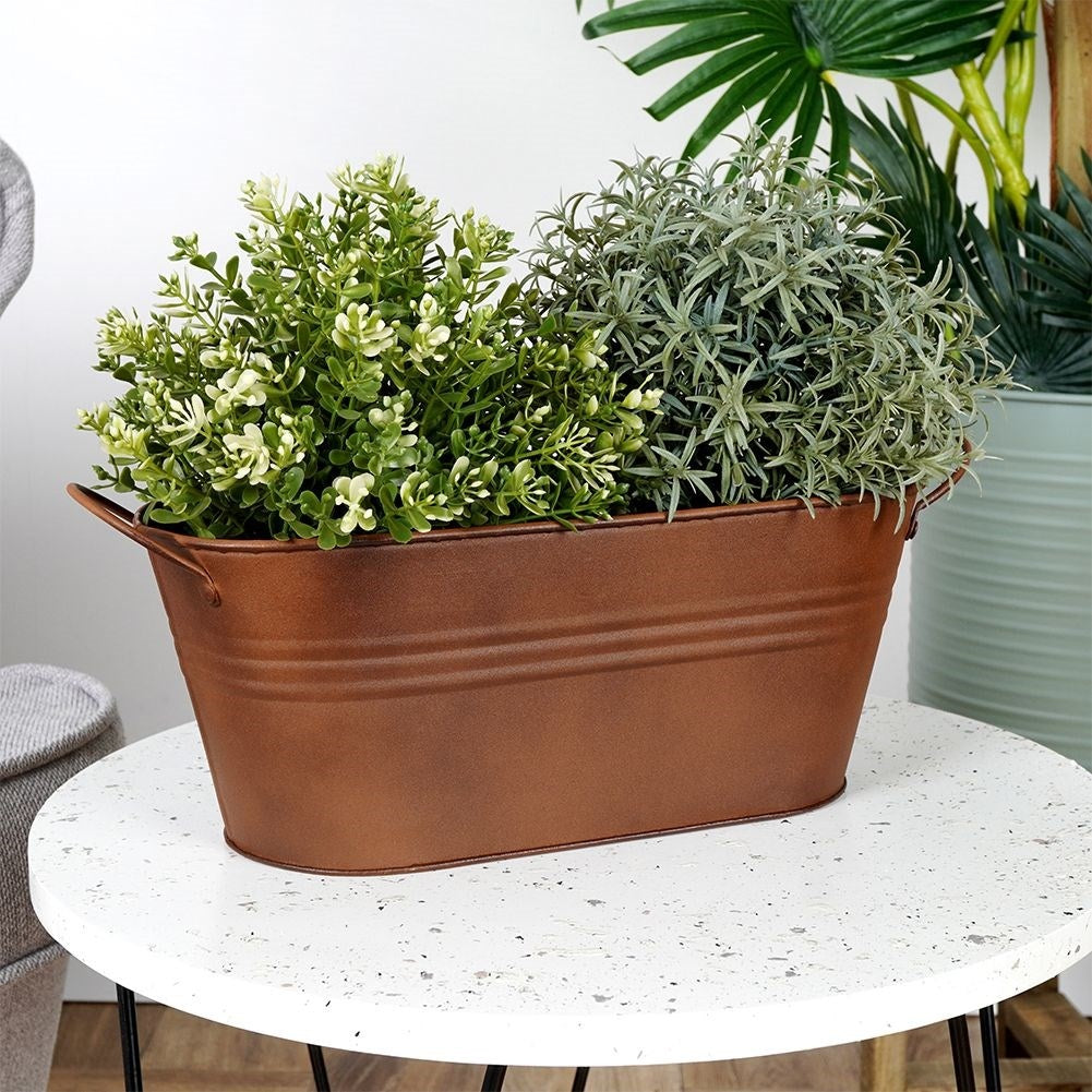 Vintage style oblong metal pot with a rusty finish