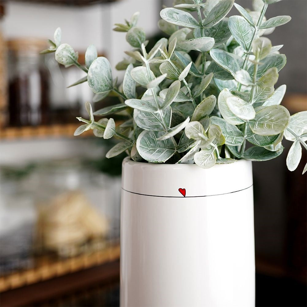 White ceramic vase with subtle floral heart motif