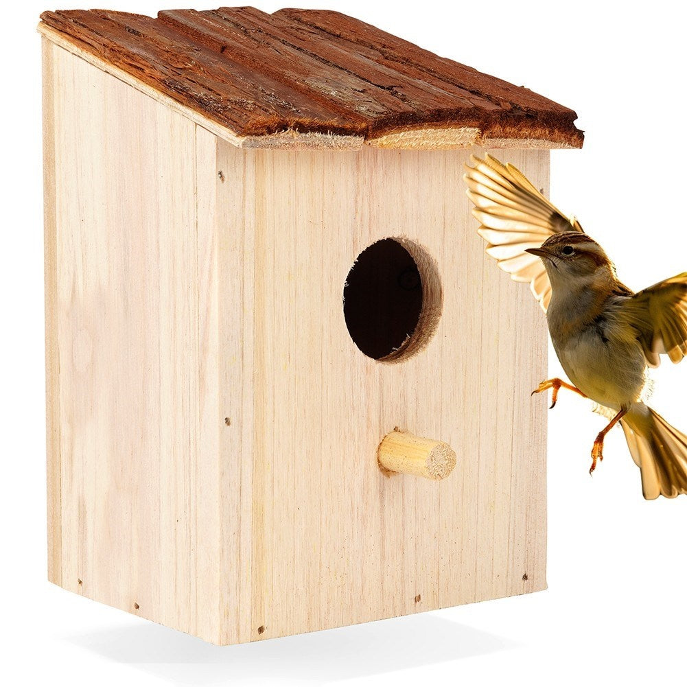 Wooden birdhouse with entrance opening for the garden
