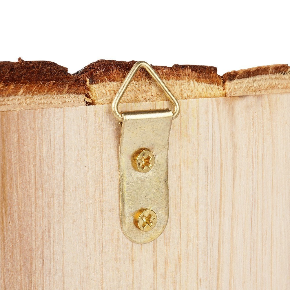 Wooden birdhouse with entrance opening for the garden