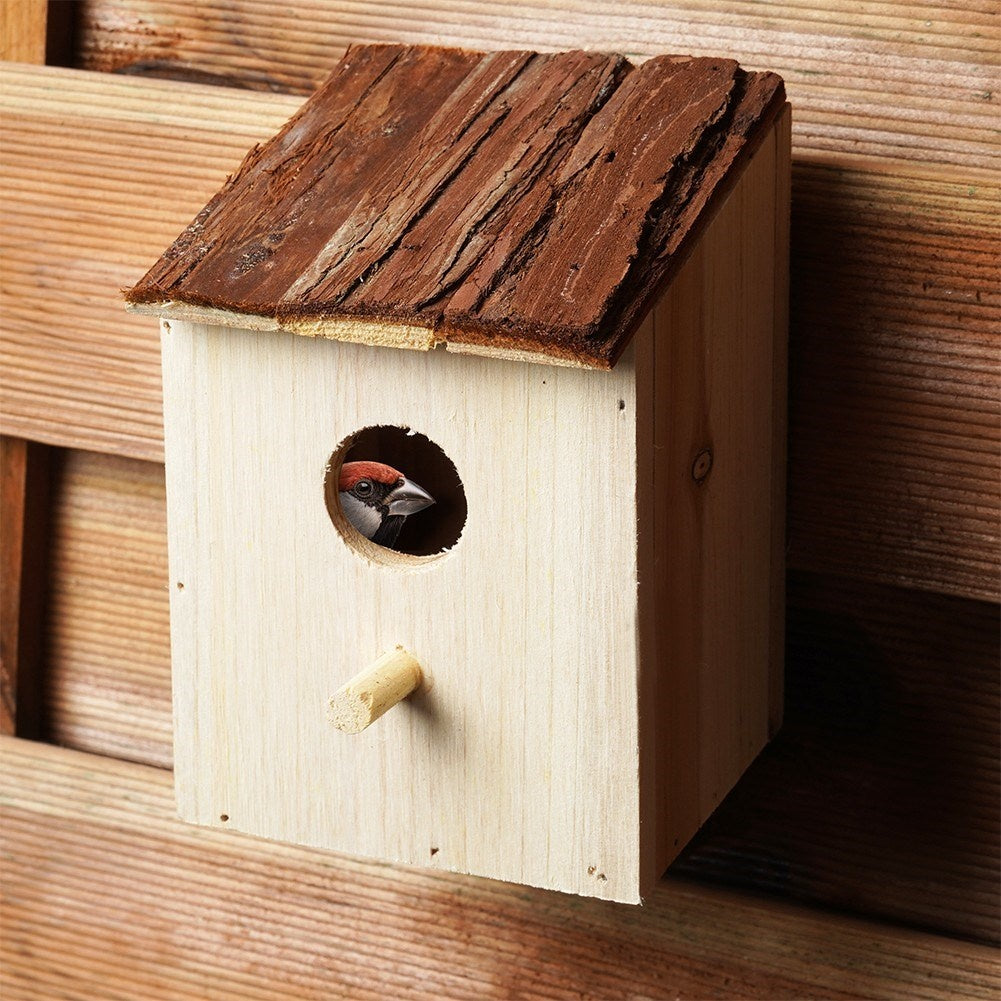 Wooden birdhouse with entrance opening for the garden