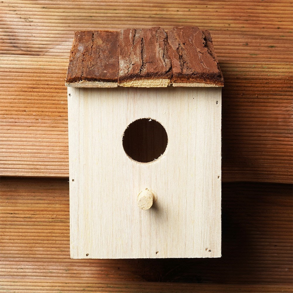 Wooden birdhouse with entrance opening for the garden