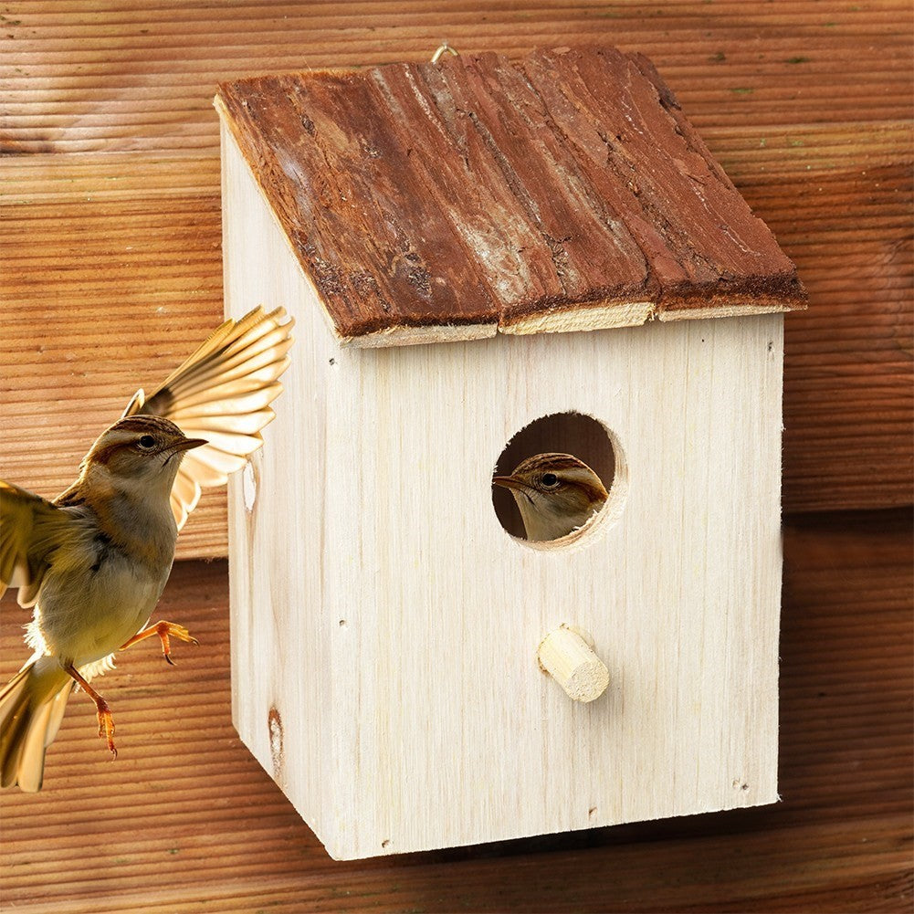 Wooden birdhouse with entrance opening for the garden