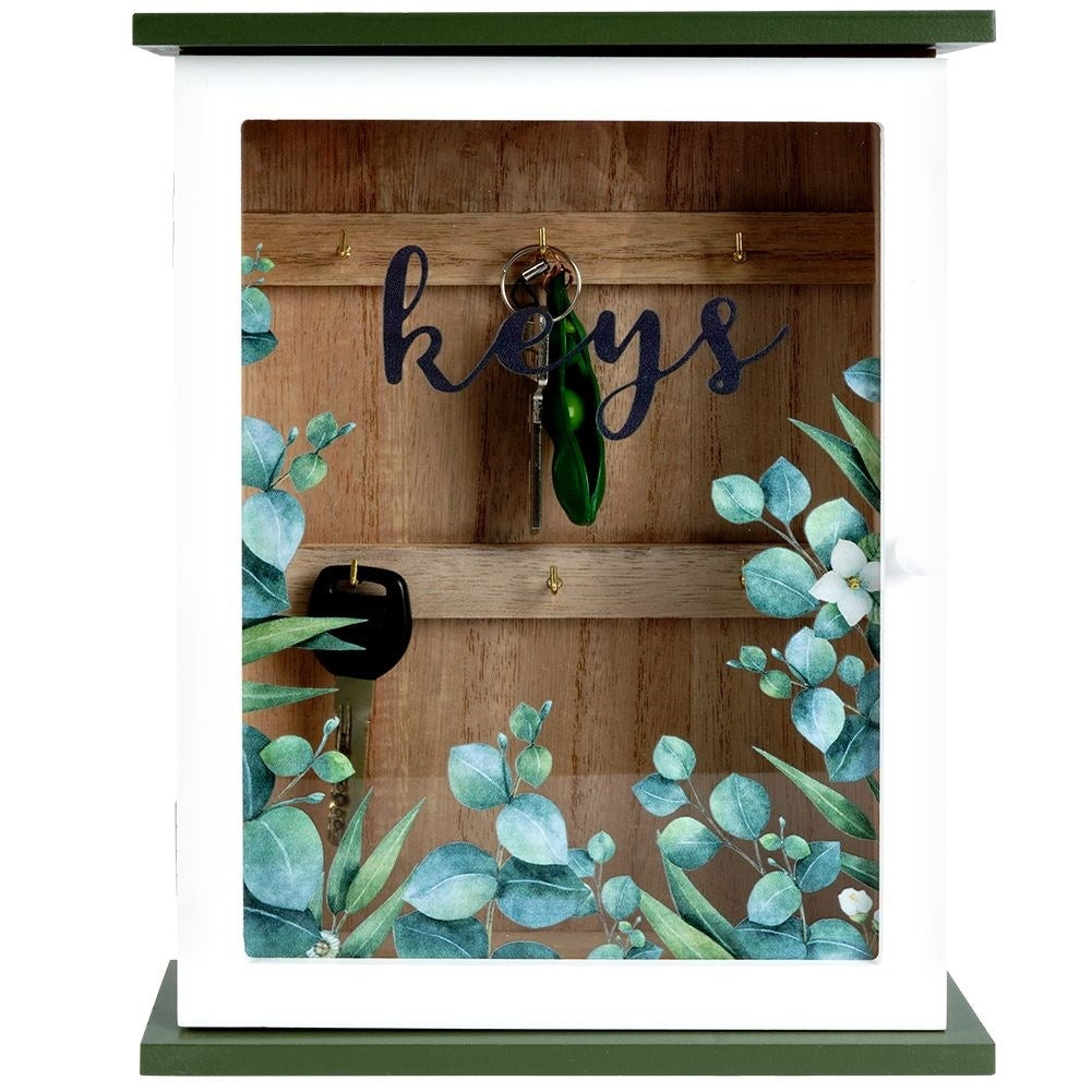 Wooden cabinet with glass doors and leaf motif for keys