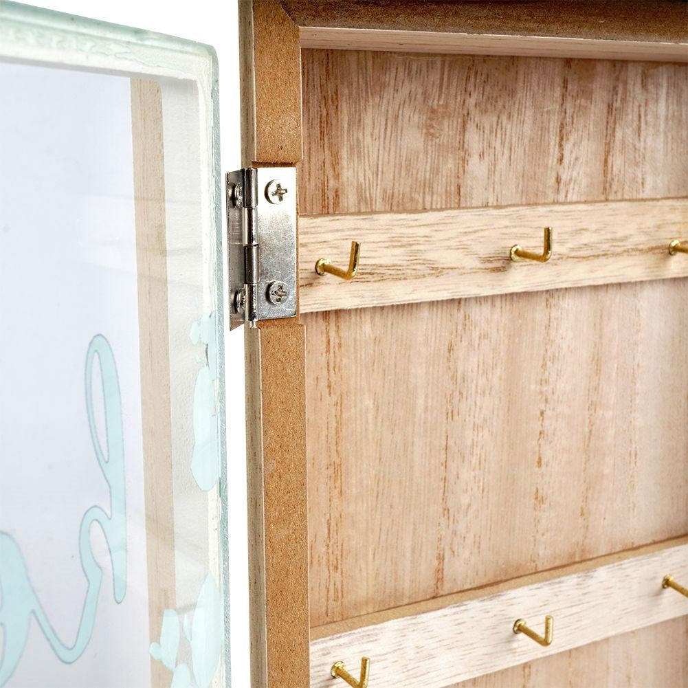 Wooden cabinet with glass doors and leaf motif for keys