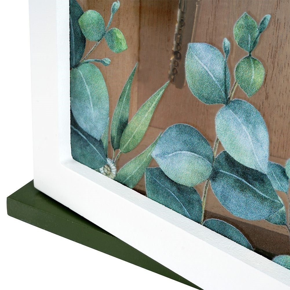 Wooden cabinet with glass doors and leaf motif for keys