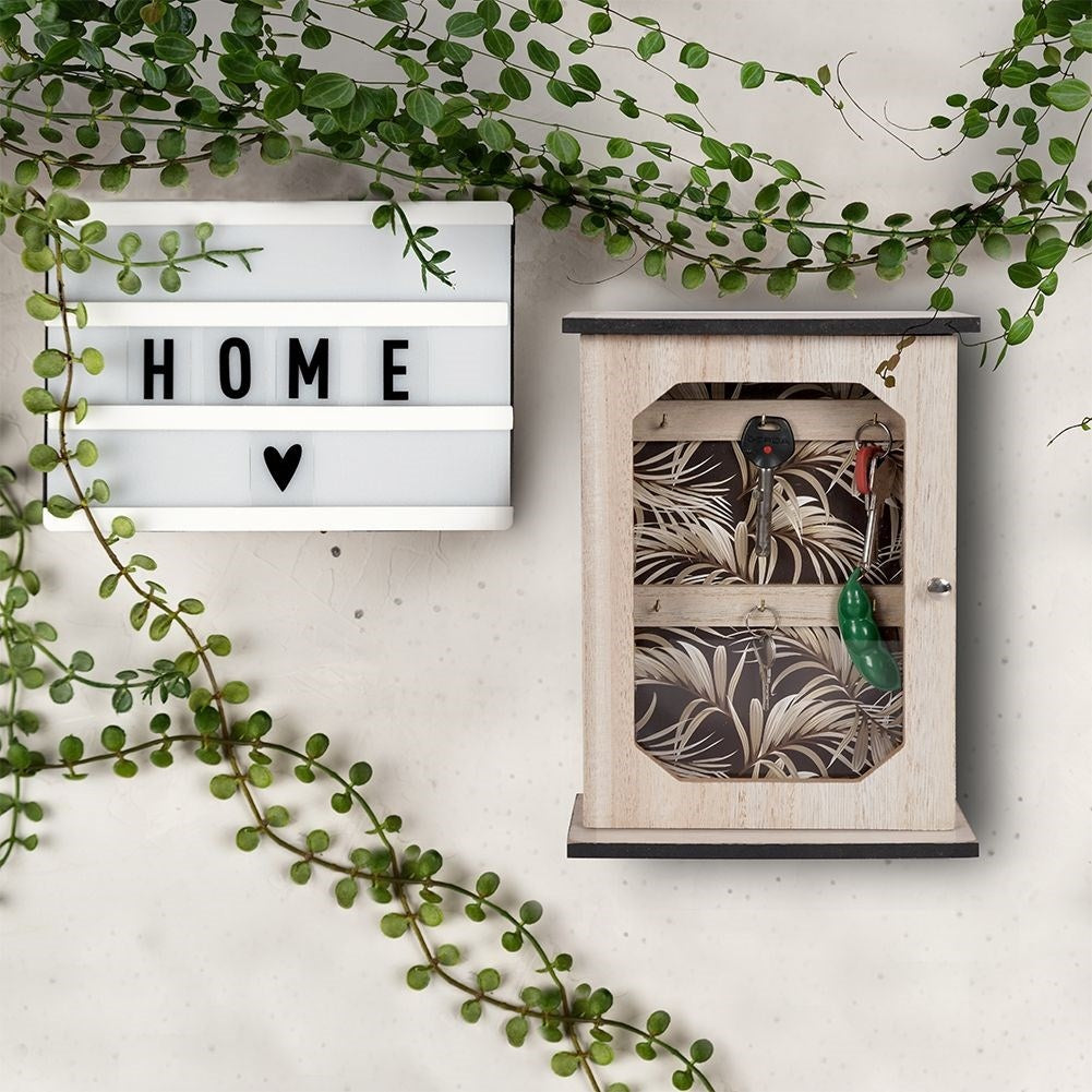 Wooden cabinet with print and six golden hooks for keys