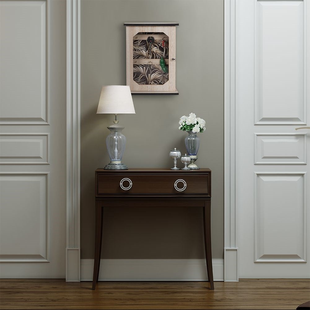 Wooden cabinet with print and six golden hooks for keys